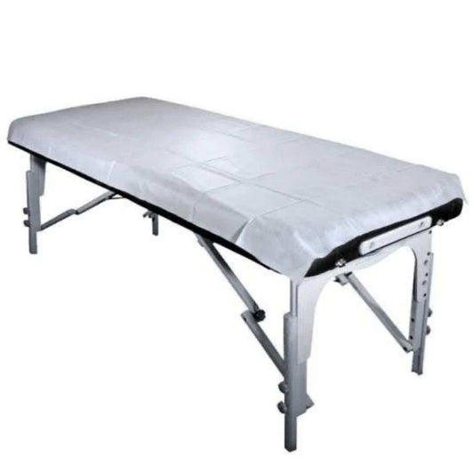 Disposable Bed Sheets in white, soft and breathable, fitted on a portable massage table with a pre-cut face hole
